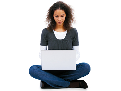 Girl sitting crosslegged using a laptop